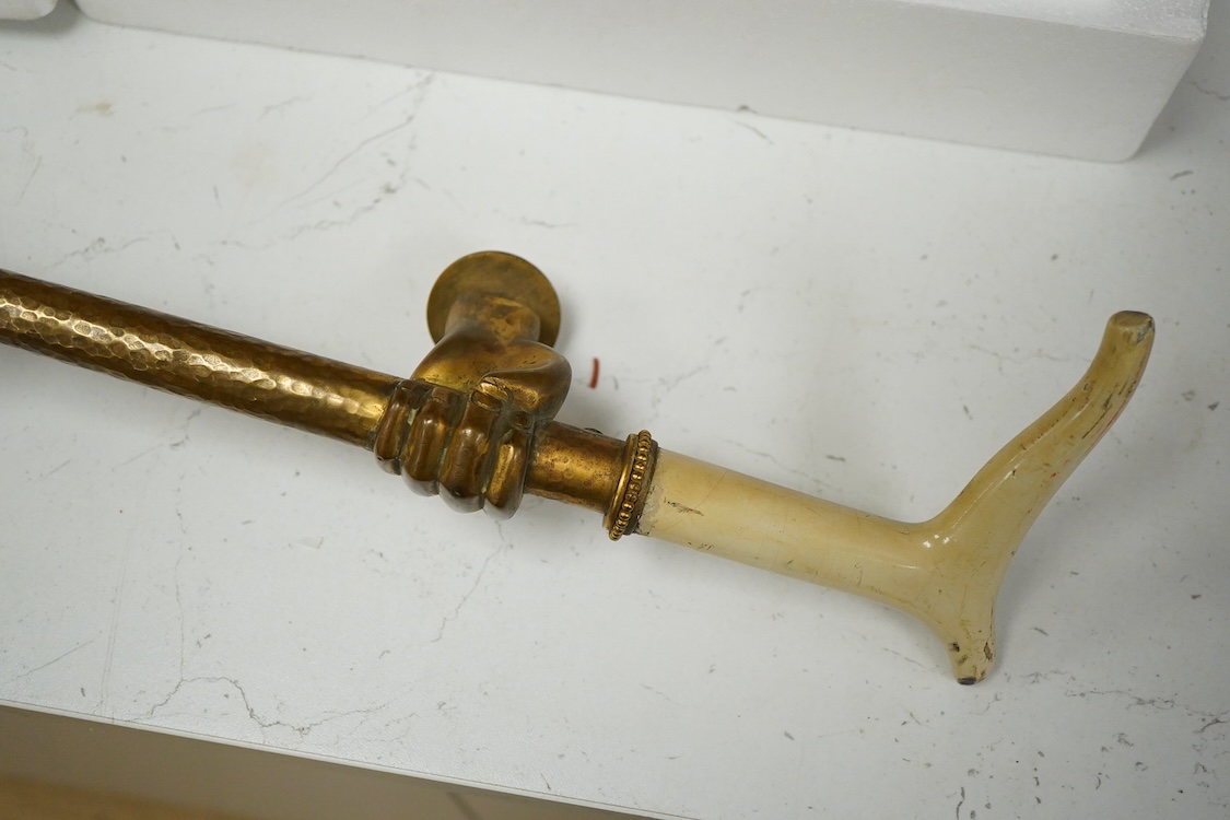 An unusual early 20th century gilt bronze or brass ‘riding crop and hand’ door handle, 65cm